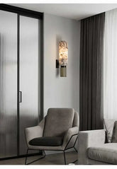 Modern interior with a gray armchair and sofa near a glass door.