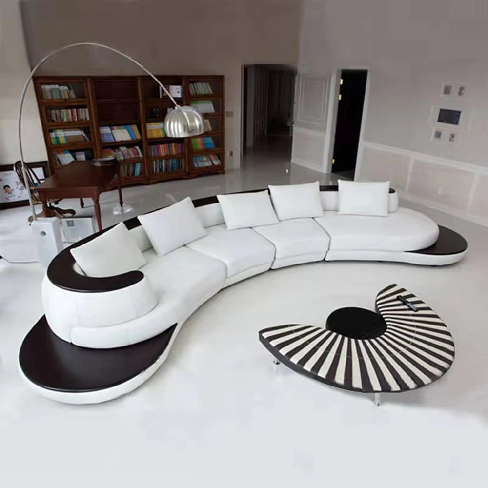 Modern white and black sofa in a room with a bookshelf and floor lamp.