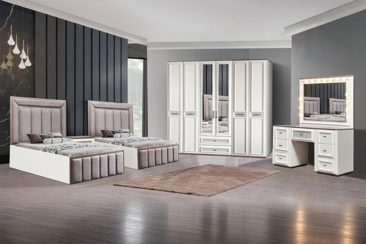 A modern bedroom furniture set shown in a staged room, including two single beds with tufted gray upholstered heads and footboards, a tall mirrored wardrobe, and a white vanity table with a matching mirror. The room has gray walls, wood flooring, and a brown rug.