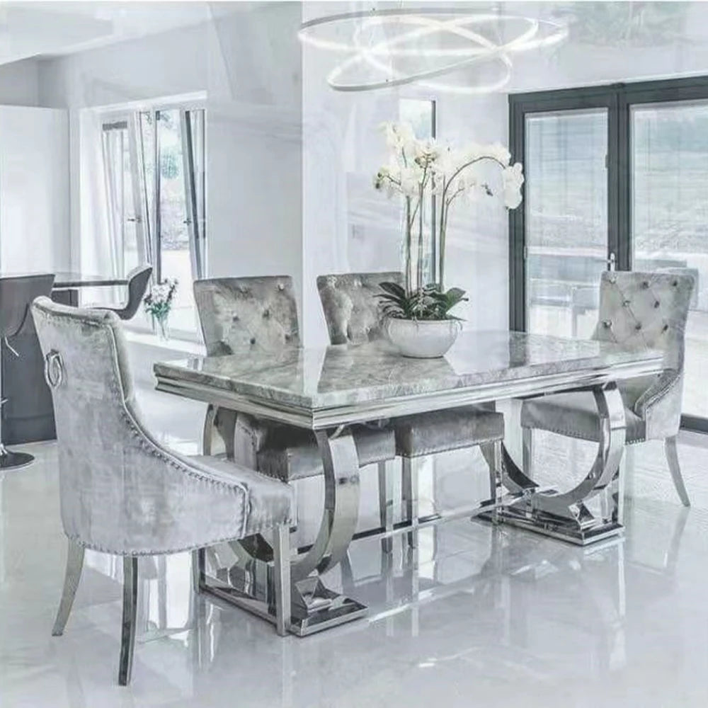 Luxury marble dining table set featuring designer silver frame and elegant chairs, perfect for a modern dining room.