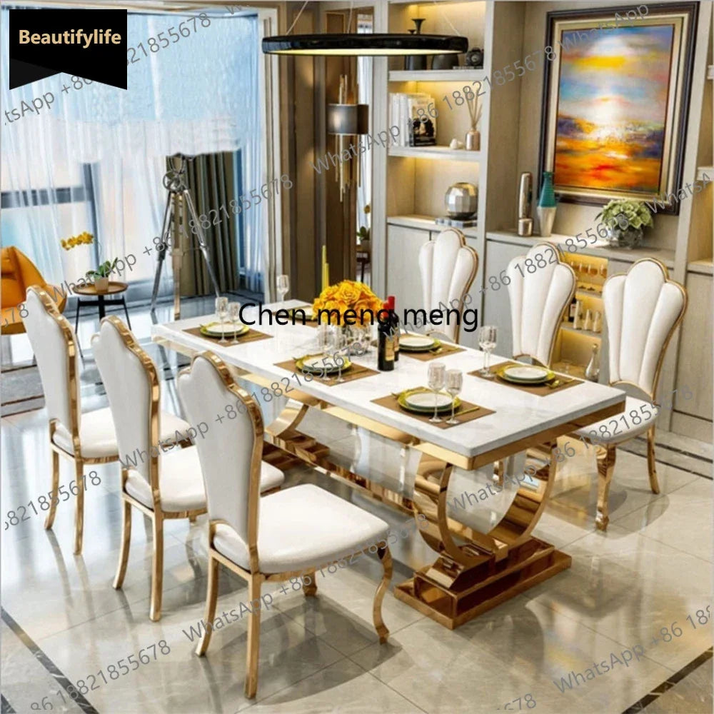 Luxury marble dining table set with designer silver frame and four elegant chairs in modern dining room.