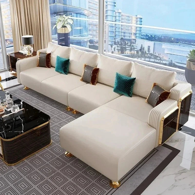 Modern white sectional sofa with decorative pillows in a stylish living room with city view.