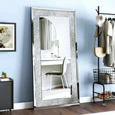 Large silver rhinestone mirror reflecting a modern room with a desk and stylish decor.