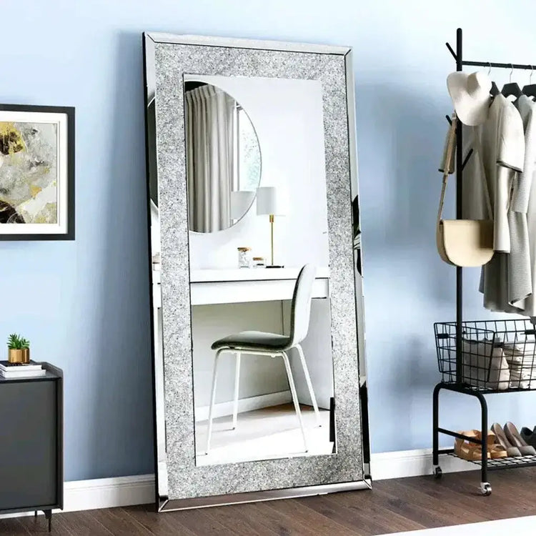 Large silver rhinestone mirror reflecting a modern room with a desk and stylish decor.
