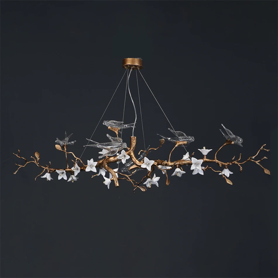 Decorative chandelier with branches and birds on a dark background