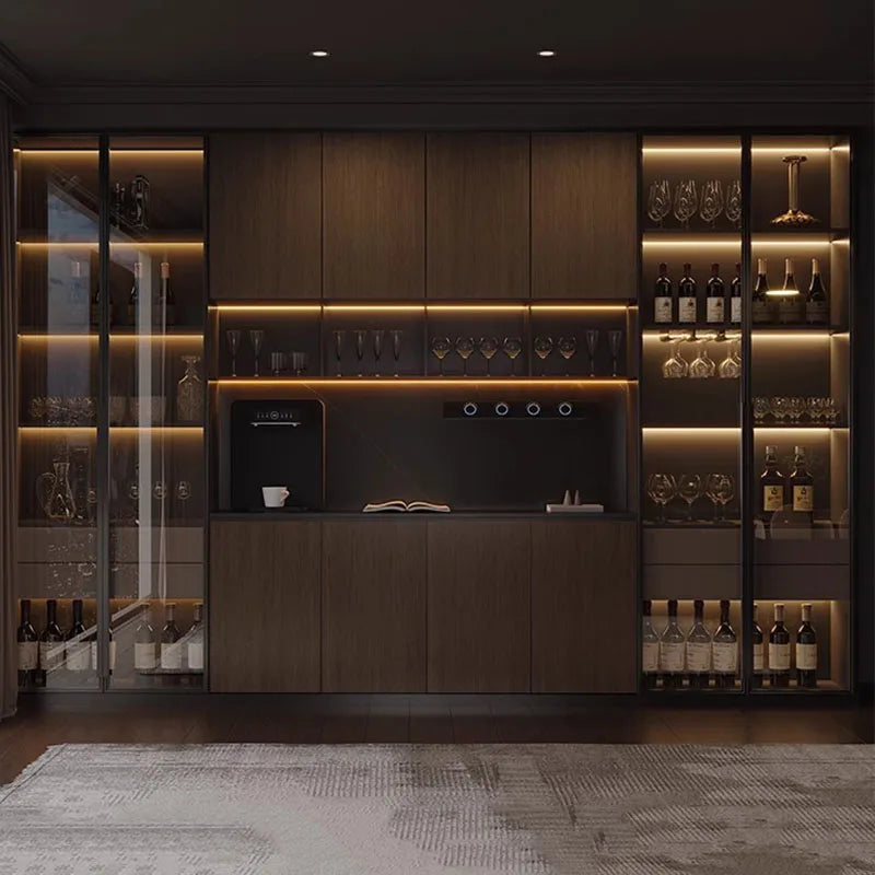 Modern kitchen with wooden cabinets, wine bottles, and a coffee machine.
