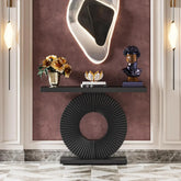 Decorative console table with a round base and shelf against a wall with a textured finish.