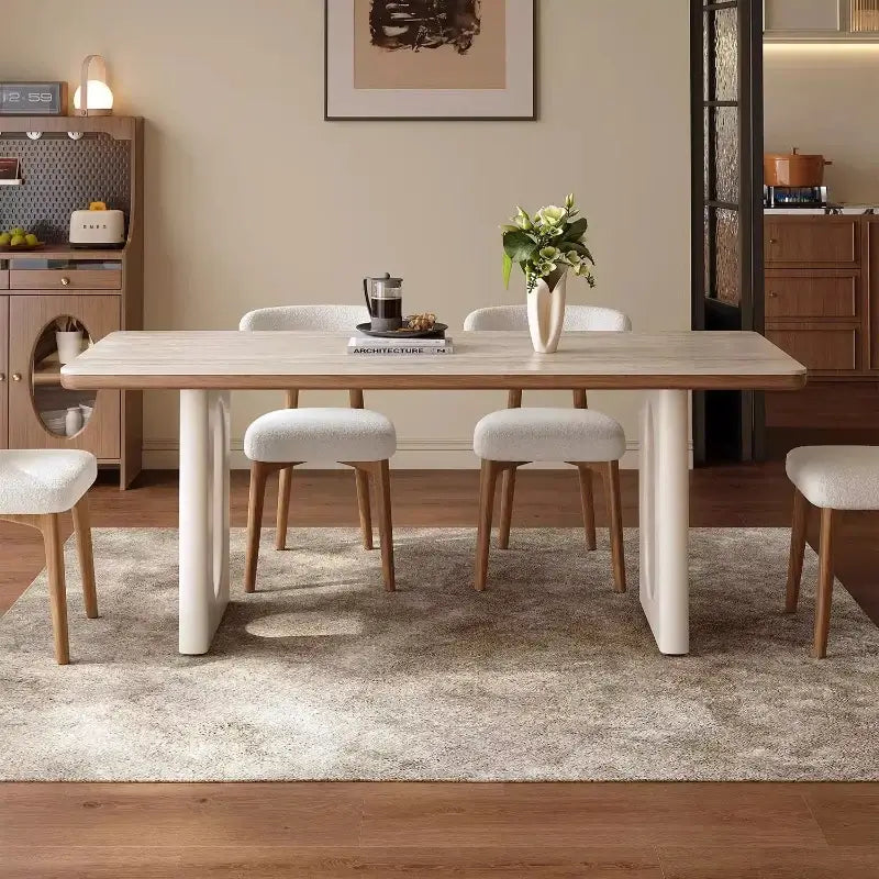 Dining room with a table and chairs in a well-lit room.