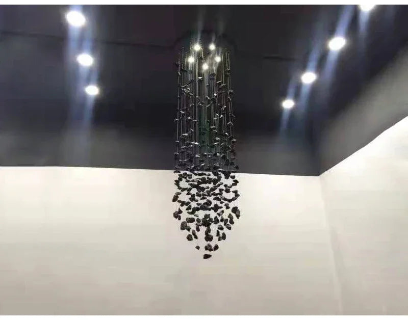 Modern chandelier hanging from a ceiling with lights on