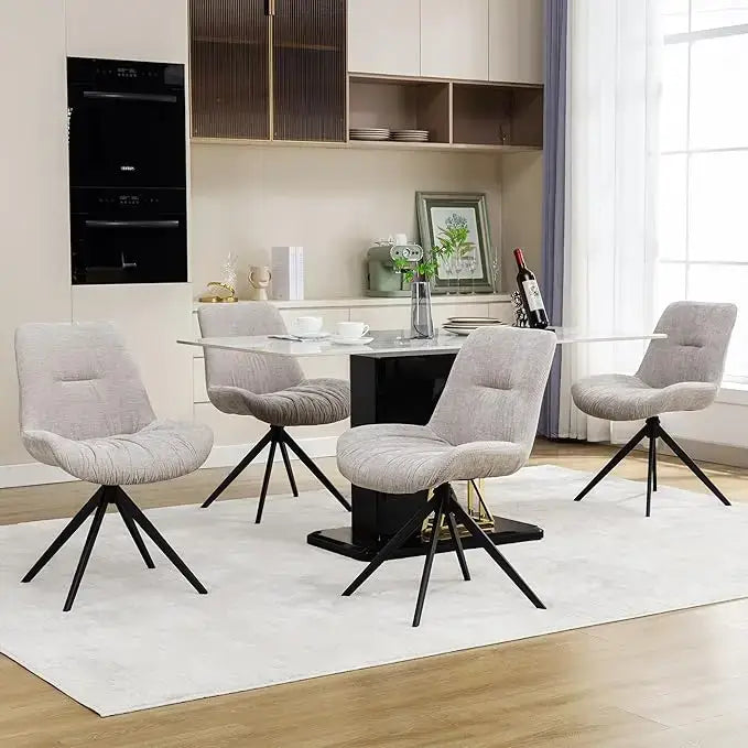 Set of 4 white swivel dining chairs set around a modern glass dining table in a stylish interior.