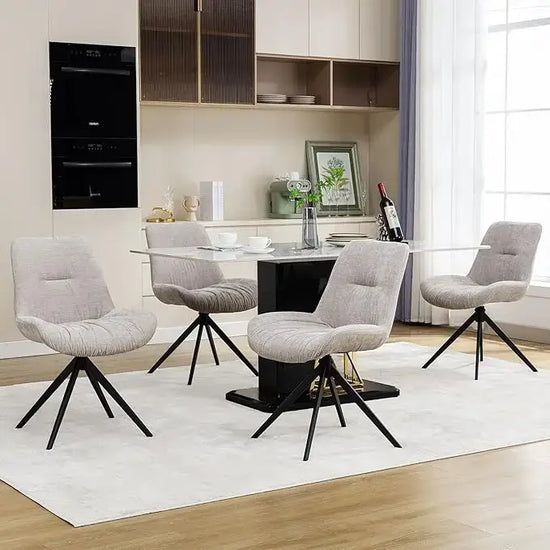 Set of 4 white swivel dining chairs set around a modern glass dining table in a stylish interior.