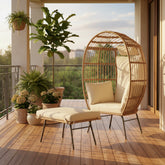 Wicker chair with cushion and matching ottoman on a porch balcony with flowers 