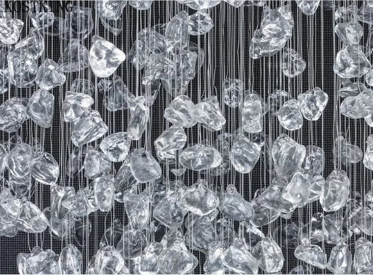 Crystal-like shapes hanging vertically against a black background