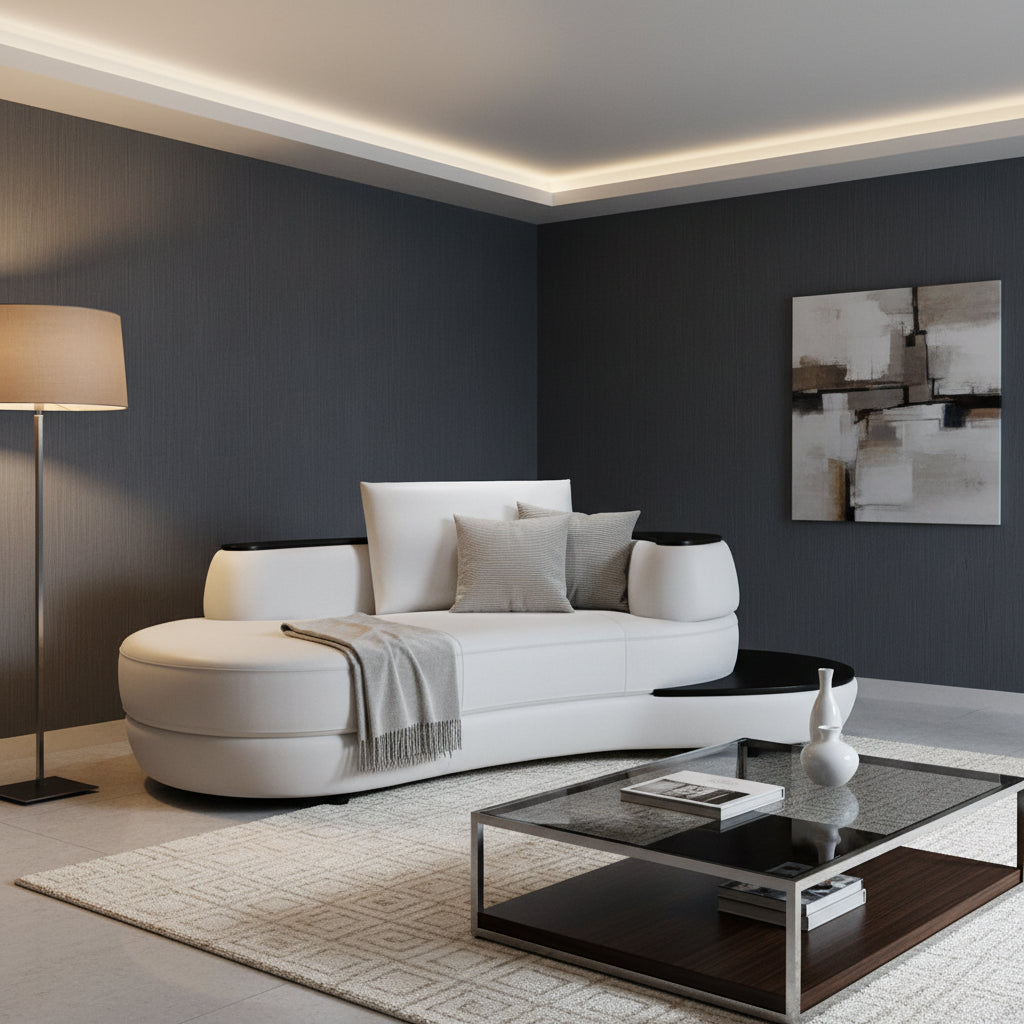 Modern white and black sofa in a living room setting with blue walls & lighting on a cream rug with a coffee table 