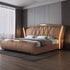 Modern bedroom with a brown upholstered bed in a well-lit room.