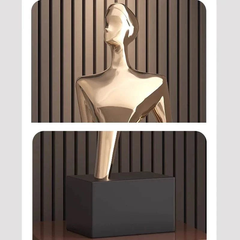 Gold statue on a black pedestal against a striped background