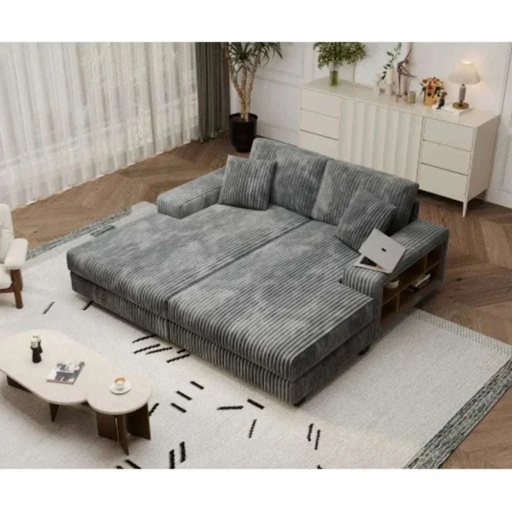 Gray sectional sofa in a living room setting with a coffee table and decorative items.