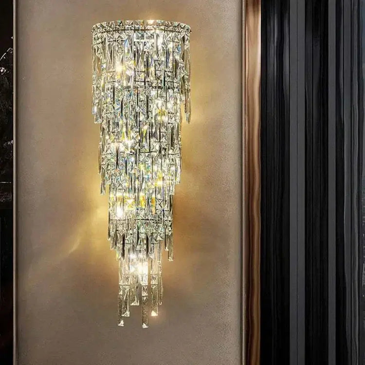 Elegant crystal wall lamp with a modern design, showcasing shimmering crystals and warm lighting in a stylish setting.