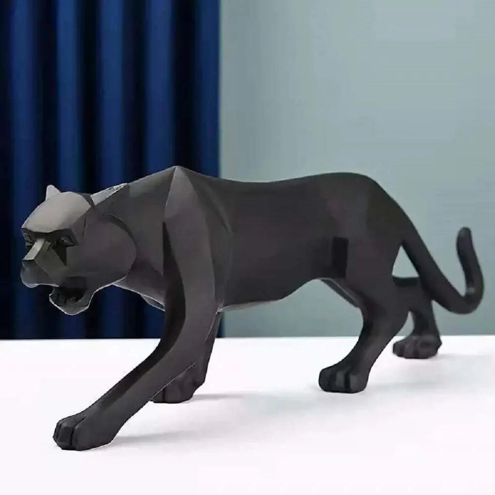 Black panther figurine on a white surface with a blue curtain background