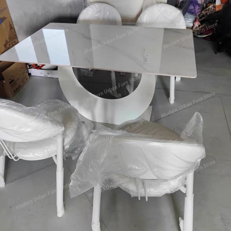 Luxury Nordic dining set featuring a sleek slate tabletop and stylish white chairs.