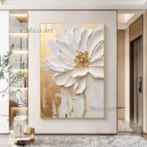 Decorative painting of a white flower with gold accents on a wall in a modern interior setting.