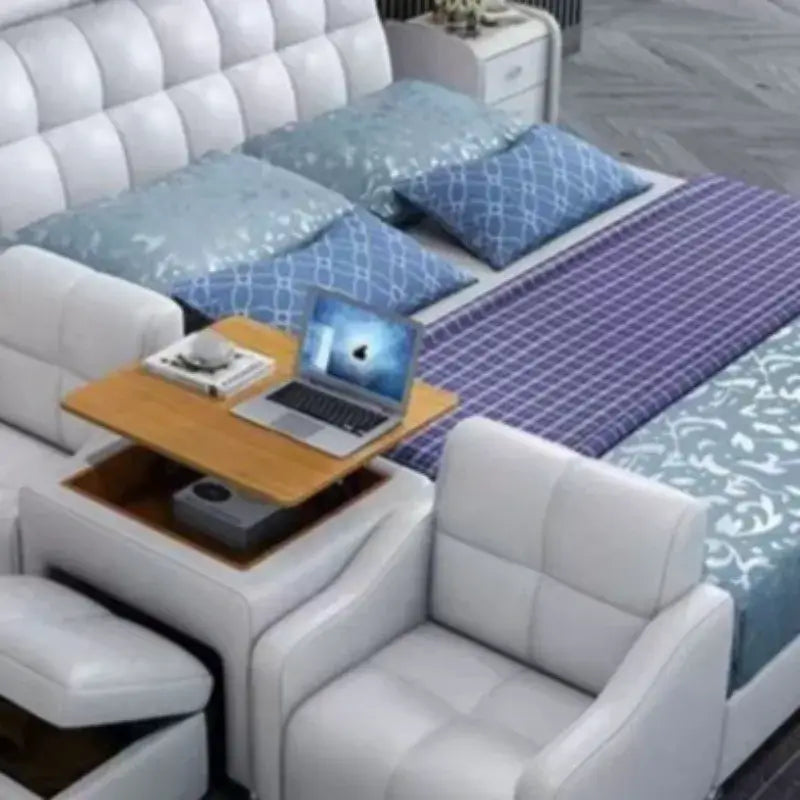 luxury smart leather king size bed with blue pillows, wooden side table, and laptop on the surface.
