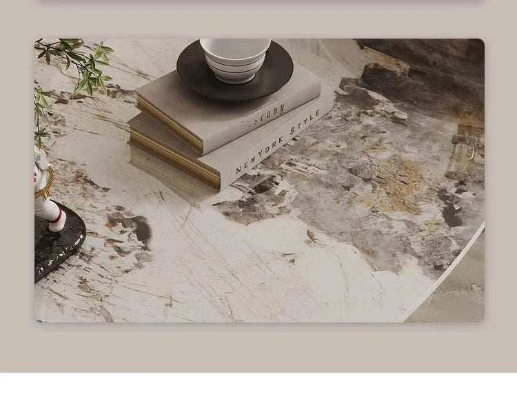 Stack of books on a marble surface with a cup and saucer.