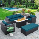 Outdoor patio furniture set with fire pit table on a patio area with pool and garden in the background.