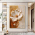 Abstract painting of a white flower with gold accents on a wall in a modern interior setting.