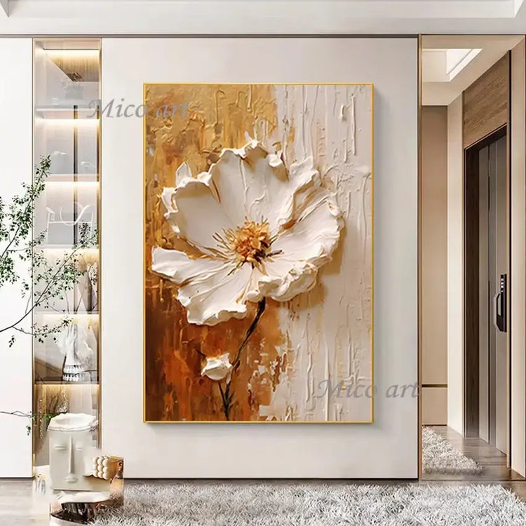 Abstract painting of a white flower with gold accents on a wall in a modern interior setting.