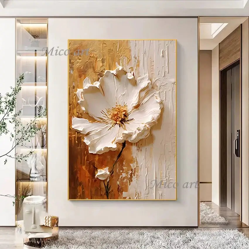 Abstract painting of a white flower with gold accents on a wall in a modern interior setting.