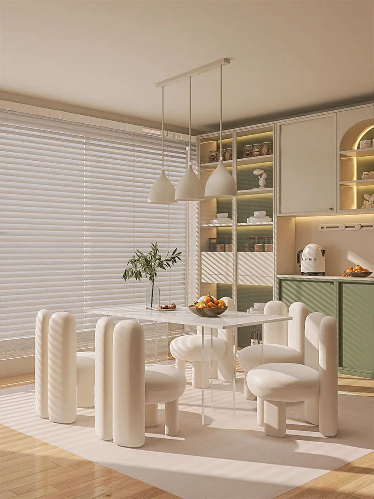 Modern dining area featuring the rock slab dining table set with white chairs and stylish decor.