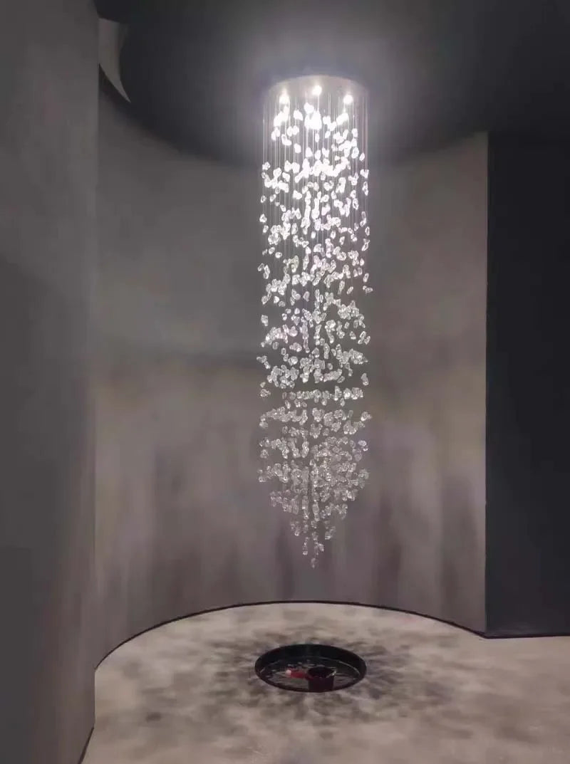 Luxury crystal stone chandelier hanging in a modern space, emitting elegant LED light and showcasing crystal accents.
