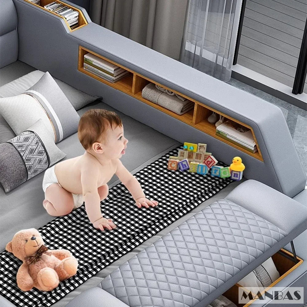 Baby playing on a checkered mat in a living room with a teddy bear and colorful blocks.