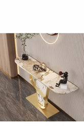 Decorative console table with marble top and gold base in a room setting.