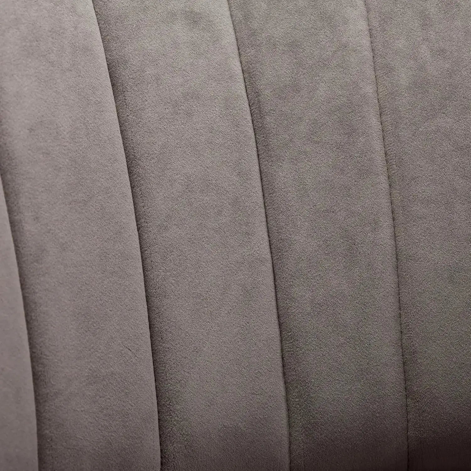 Close-up of the plush upholstery on modern swivel barrel chairs in soft gray fabric.