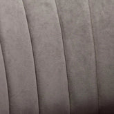 Close-up of the plush upholstery on modern swivel barrel chairs in soft gray fabric.