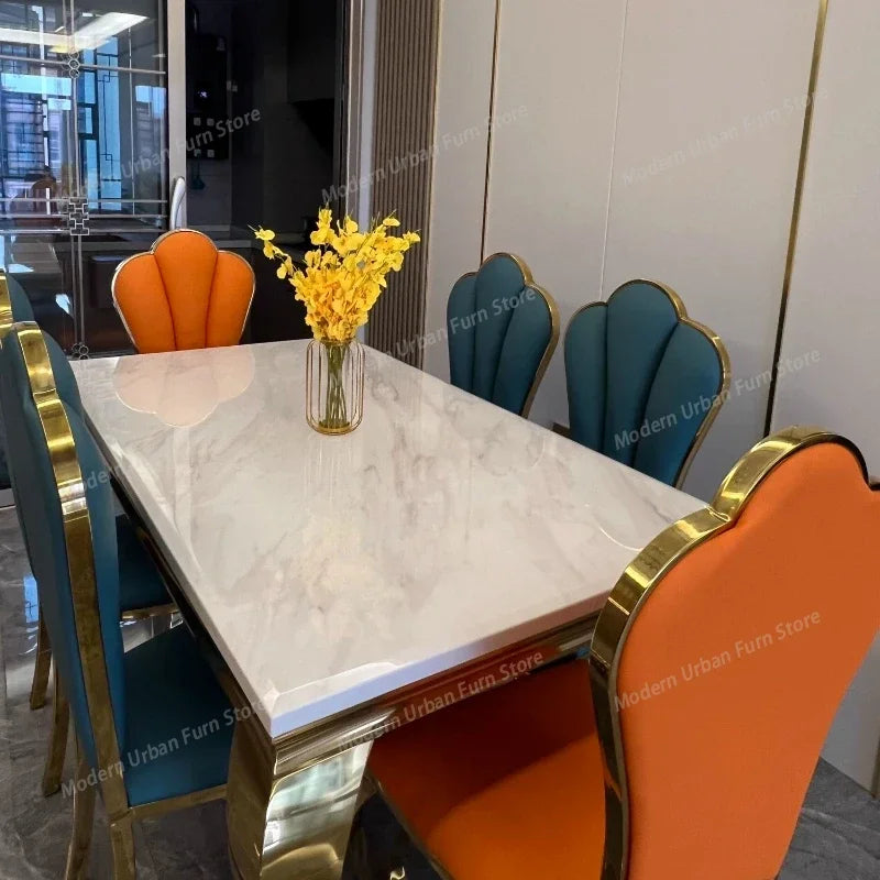Italian Rock Slab Dining Table Set with colorful chairs and vase of flowers, showcasing luxury dining table with chairs.