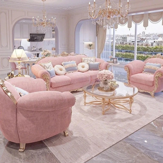 Luxurious living room with pink velvet sofa and armchair, gold accents, and large windows.