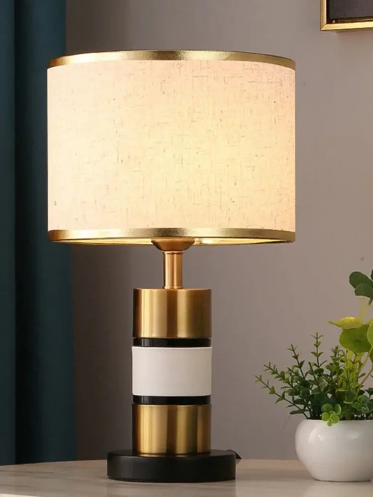 Luxury LED bedside lamp showcasing modern design with gold frame, fabric shade, and stone-quality base.