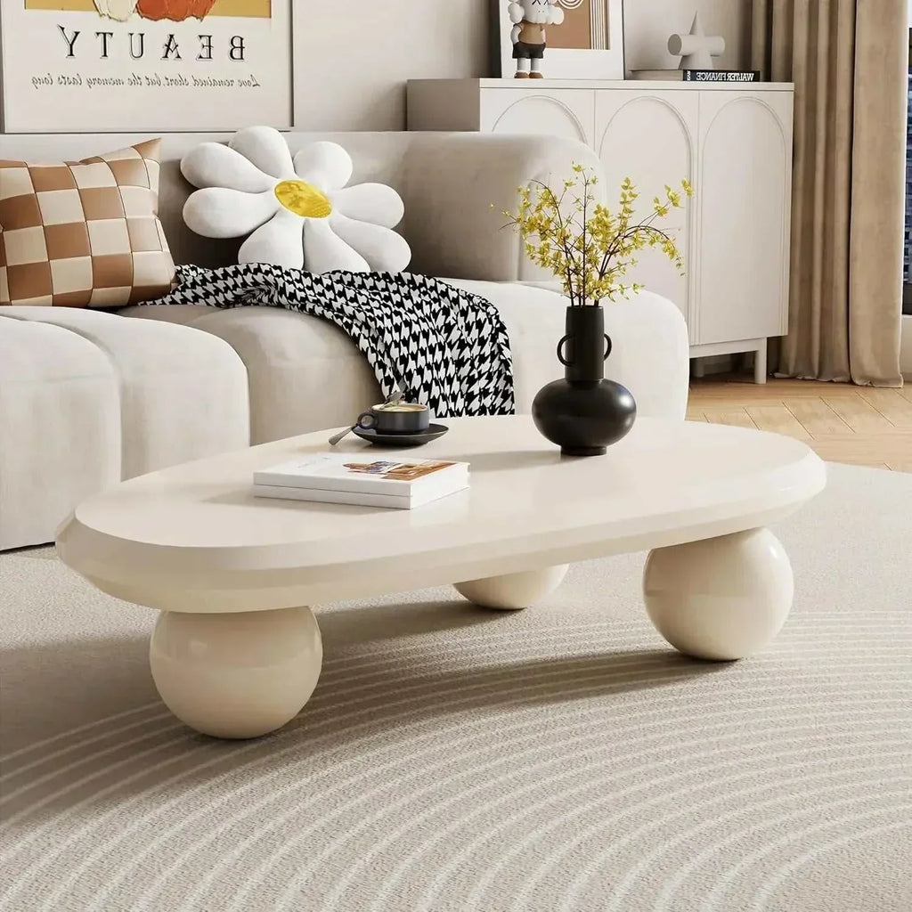 Modern living room with a white sofa, coffee table, and decorative items.