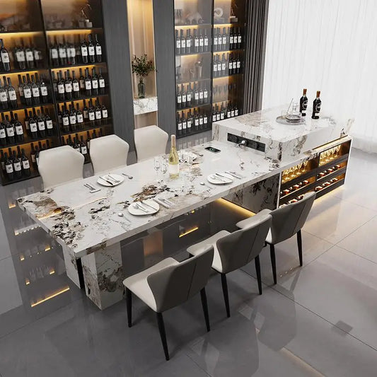 Modern dining room with marble table and chairs, wine bottles in the background