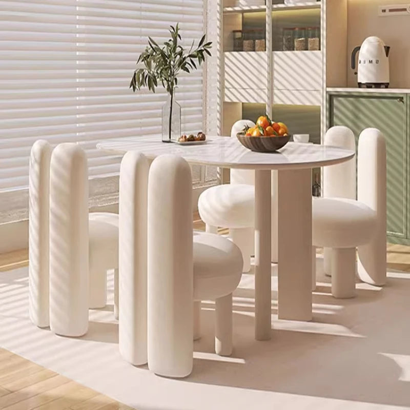 Art-Style rock slab dining table set with unique white chairs in modern kitchen decor.