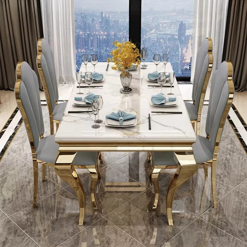 Luxury marble dining table with gold base for six people in elegant dining room setting.