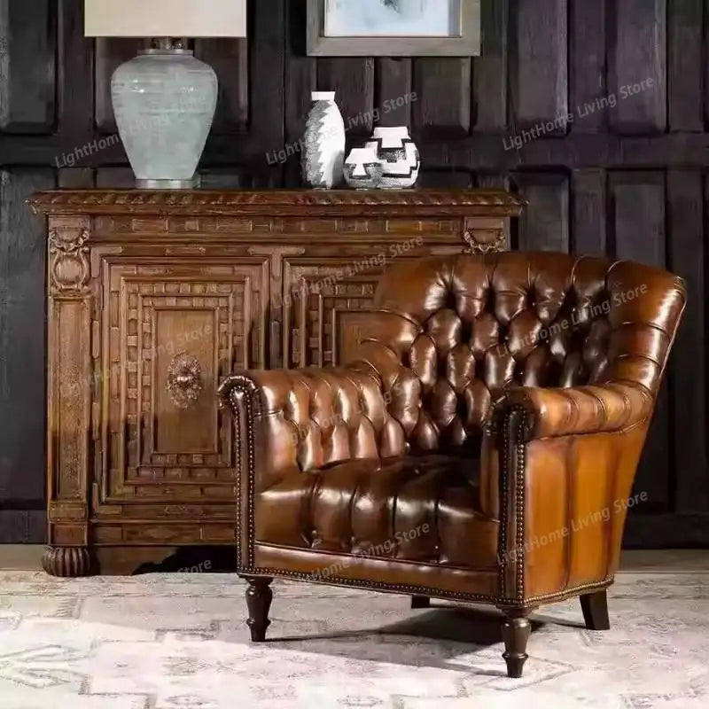 Brown leather sofa in a room with wooden furniture and decorative items.