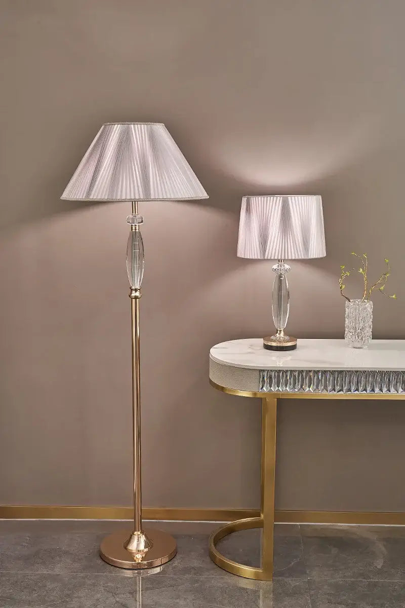 High-end crystal table lamp with fabric shade beside a matching floor lamp in elegant interior decor.