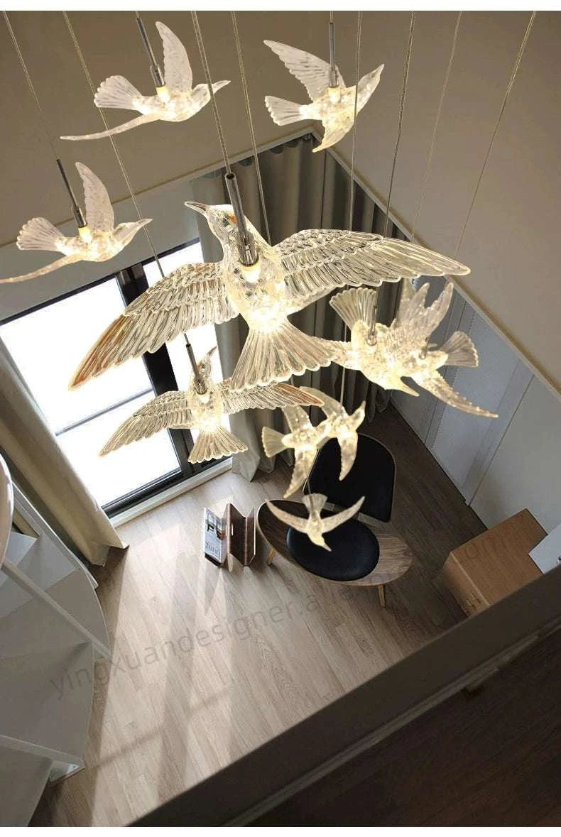 Chandelier with bird design in a room with large windows