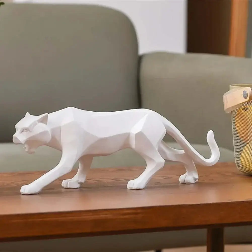White panther figurine on a wooden surface with a blurred background