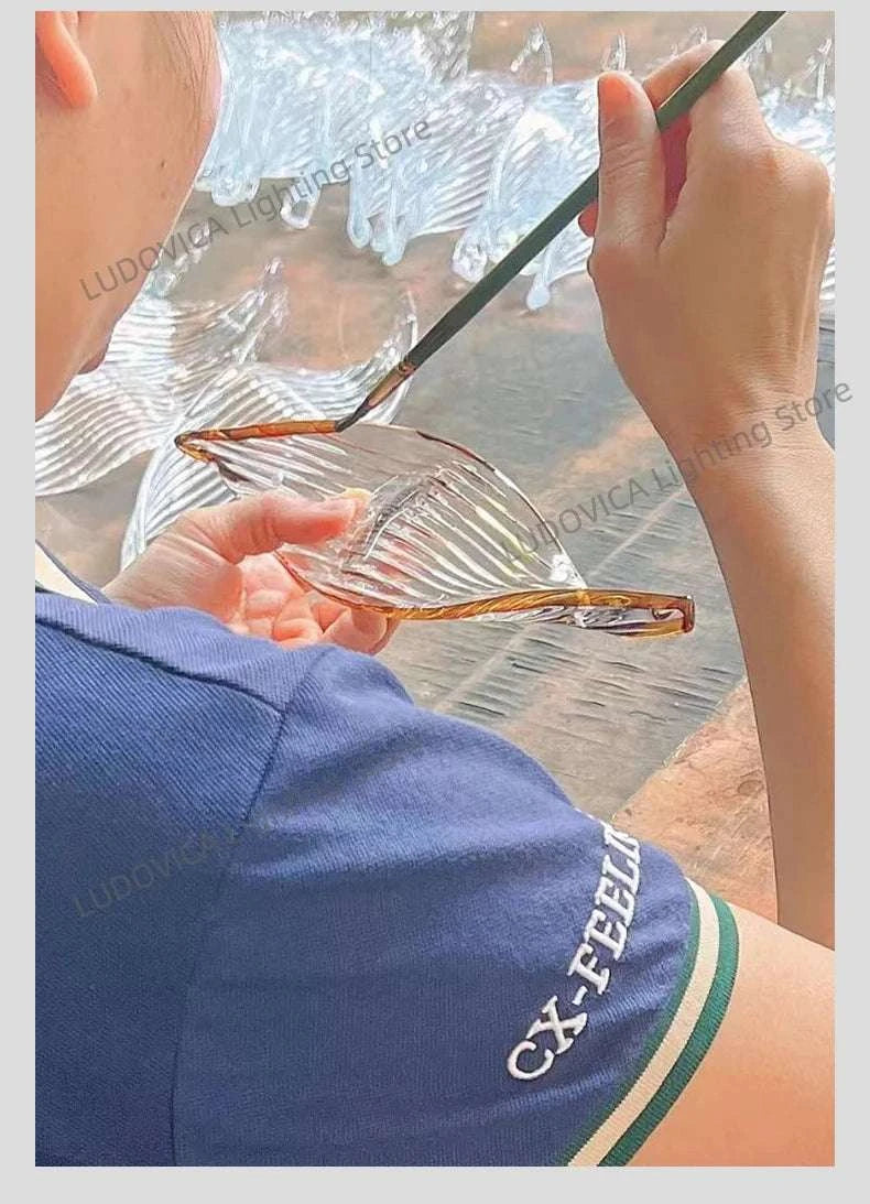 Person holding a glass object with a blurred background