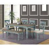 Dining room set with wooden table and chairs in a room with gray walls and a rug.